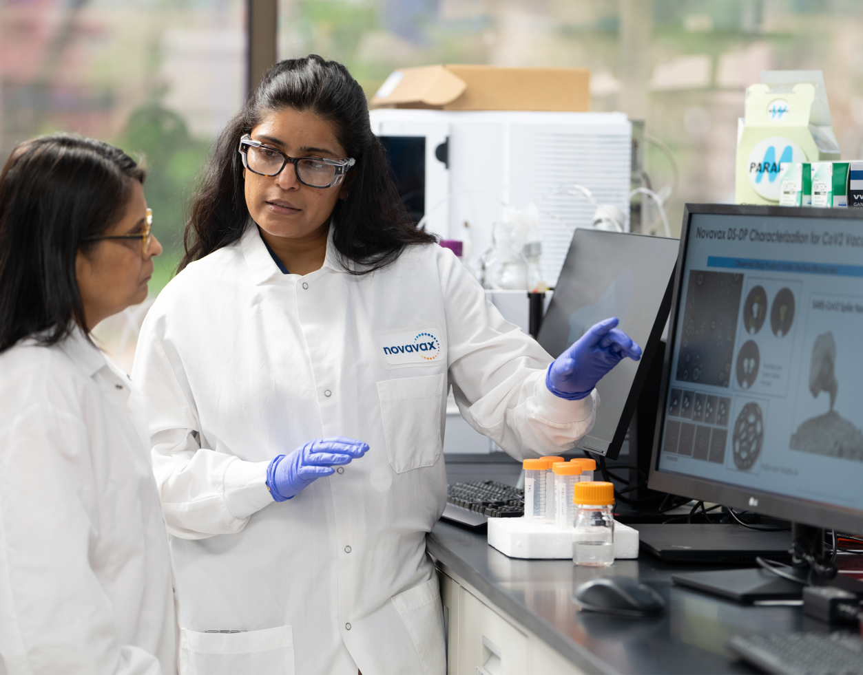 two scientists in front a computer in a lab